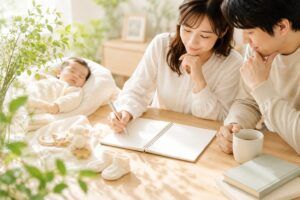 一文字・二文字・三文字の名前で迷う親御様が、赤ちゃんのそばで姓名判断の画数や苗字とのバランスを考える明るいイメージ画像